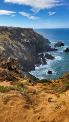 The Almograve Beach With Black Basalt Rocks in Alentejo Coast, Portugal. In the Footsteps of Rota Vicentina. Hiking Fisherman Trail.
