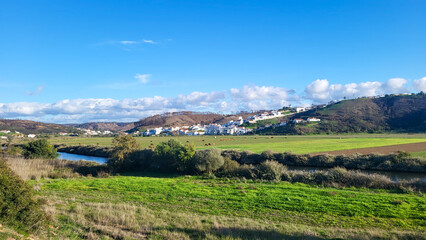 Praia De Odeceixe Mar Beach With Golden Sand, Atlantic Ocean, River Bend and White Houses of Odeceixe Village. Rota Vicentina Coast, Odemira, Portugal. Hiking Rota Vicentina the Fisherman's Trail