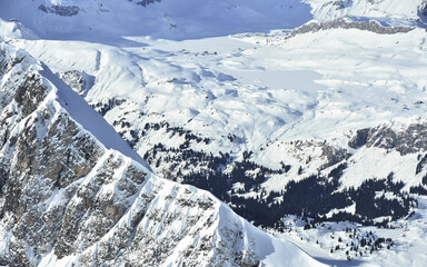 A rocky ridge covered with deep snow in the Swiss Alps. Frozen landscape, the rocky mountains are...