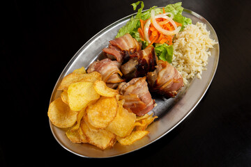 Traditional Alentejo recipe: Black pork loin bites wrapped in bacon – a delicious delicacy capturing Portugal's culinary heritage.