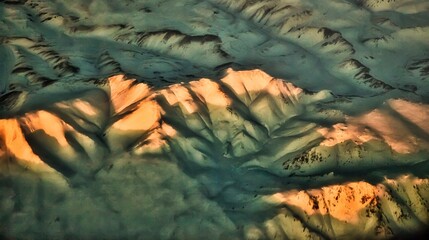 Chengdu, China - November 29 2009 : the last sun of the day is on the summits in snow of the kyrgyzstan mountains