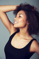 Woman, afro and hair care for natural beauty in studio or curly treatment, grey background or...