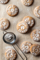 Homemade gingerbread cookies on parchment background Top view. Christmas traditional desserts concept