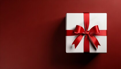 white gift box or top view of white present box tied with red ribbon bow on dark red background with empty space on the left side minimal conceptual 3d rendering