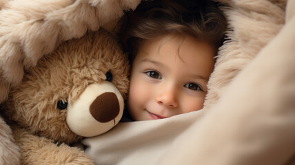 child girl in the blanket with teddy bear toy close up photo