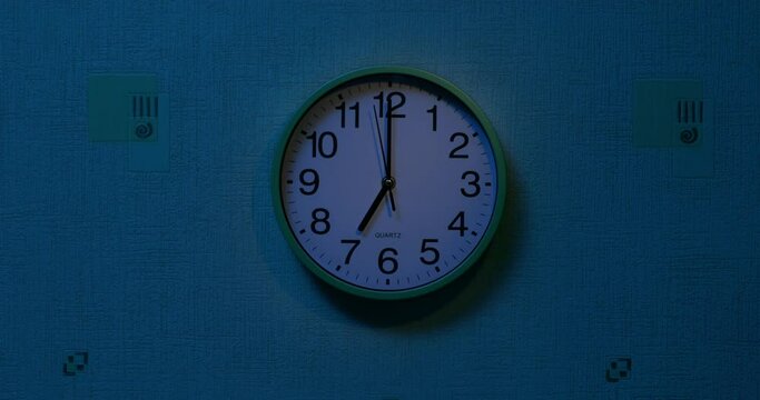 The clock on the wall reads seven a.m. - wake-up time.