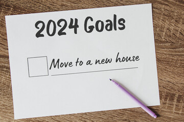planner of goals and plans for 2024, a sheet of paper with the inscription move to a new house from...