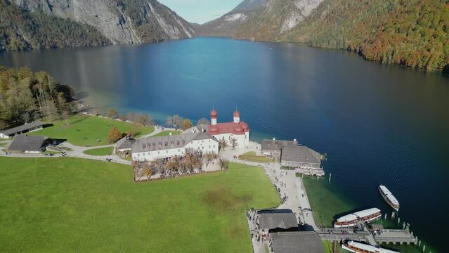 The drone aerial footage of Lake Konigsee with Sankt Bartholomae pilgrimage church, Berchtesgadener land, Bavaria, Germany.