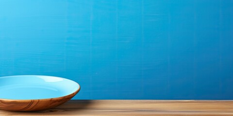 Plate on table on wooden table on blue background.