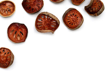 Dried bael fruit slices on white background. - Powered by Adobe