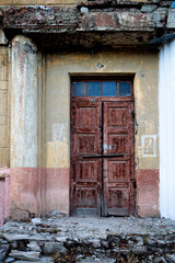 Fototapeta na wymiar Old boarded up door with peeled paint