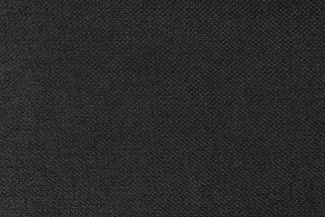 Textile background, black coarse fabric texture, jacquard woven upholstery, furniture textile material, wallpaper, backdrop. Cloth structure close up.