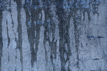gray texture of stone concrete wall and frozen water in the street