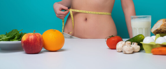 Healthy Eating. Slim waist. Woman on Diet measure waistline. Calories and diet concept. Vegetarian fresh food. Healthy metabolism. Fit perfect figure, weight loss. Diet Tips. Fitness diets Nutrition.