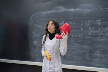 biology teacher explains to students anatomy and  organs theme in microbiology