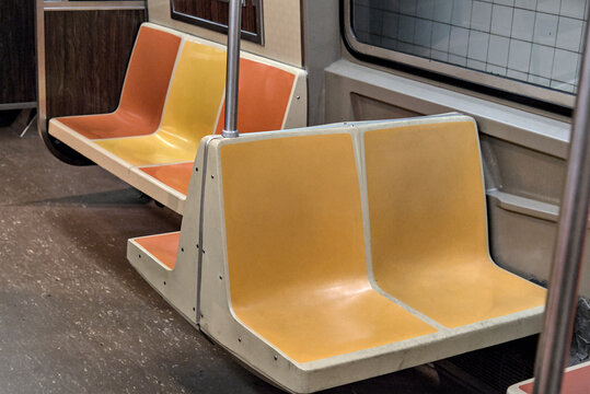orange, red and yellow subway seats in a nyc train car (commuter transport in new york city) rail railway 