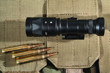  One fuel tactical ir weapon flashlight and 5.56x45mm cartridges.
