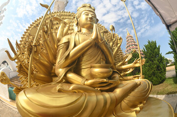 One thousand hands of golden Guan Yin Bodhisattva Statuet front of chapel at Huay Pla Kang temple....