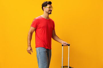 Man baggage traveler flight background yellow trip vacation suitcase studio travel happy journey
