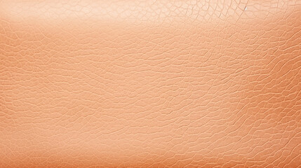 A close up of a brown leather surface. Monochrome peach fuzz background.