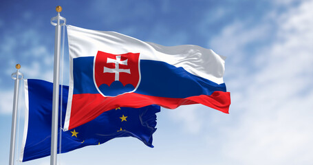 Slovakia and the European Union flags waving in the wind on a clear day