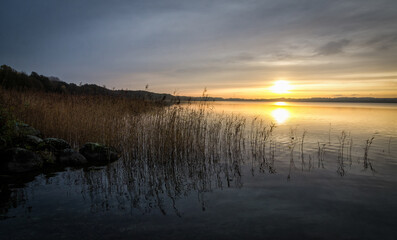 Autumn sunrise over the Swedish lake - 693244041