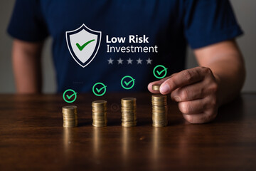 Low risk investments. Businessman saving  money with shield icon and word low risk investment,...