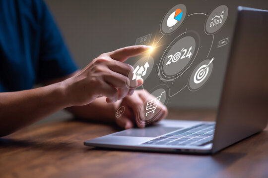 Marketing Trends for newyear 2024 concept, Businessman searching for 2024 trends for marketing monitor and business planing in new year concept.