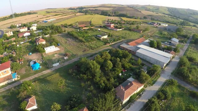Top down view beautiful village with gardens, houses, nature and roads towards the hill. Pan shot from above. Sarilar Village, Corlu in Thrace in Turkey Country. Aerial countryside village landscape
