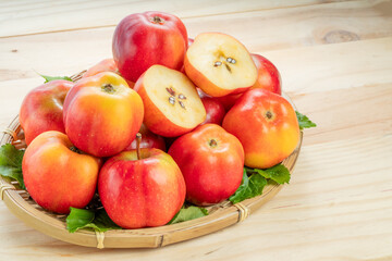 Sweet red star apple in basket on wooden table background,