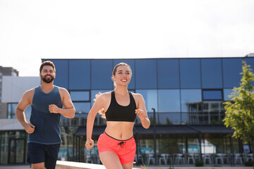 Healthy lifestyle. Happy couple running outdoors, space for text