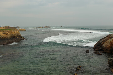 The aerial view of the waves crashing into the rocky shore of Sri Lanka