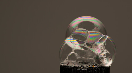 Bubbles forming in liquid showing unique patterns and designs caused by surface tension and...