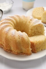 Delicious freshly baked sponge cake on white table, closeup
