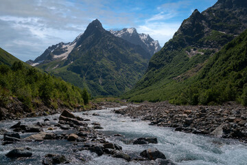 View of the Dombay-Ulgen gorge in the mountains of the North Caucasus near the village of Dombay on a sunny summer day, Karachay-Cherkessia, Russia