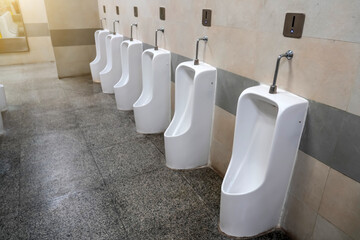 Empty row of outdoor urinals men public toilet. White ceramic urinals for man in toilet room....