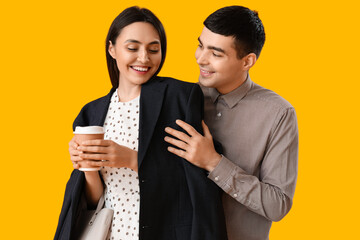 Lovely young couple on yellow background
