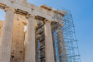 Side view of Parthenon with metal scaffolding attached for repairs.