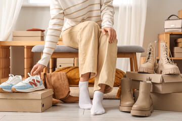 Woman trying on different shoes in shop
