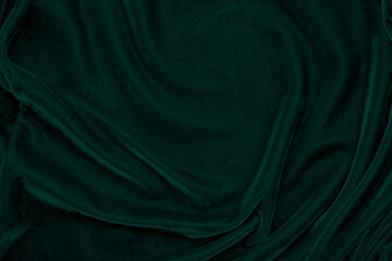 Dark green velvet fabric texture used as background. Emerald color panne fabric background of soft and smooth textile material. crushed velvet .luxury emerald tone for silk