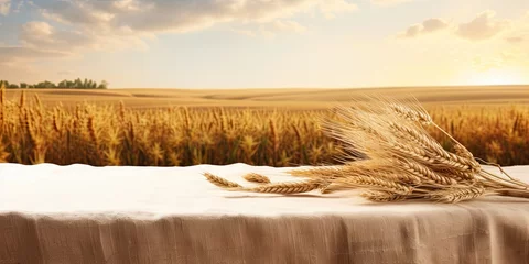 Tuinposter Shavuot holiday design and product display with wheat field background and tablecloth-covered wooden table. © Vusal