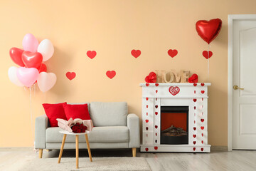 Interior of festive living room with grey sofa, fireplace and decorations for Valentine's Day...