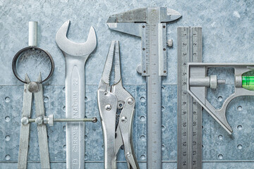Construction Tools On Metalic Background.