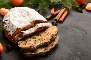 Tasty Christmas stollen on black background