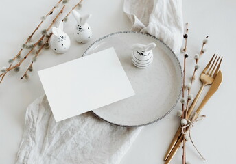 Easter table setting with Card mockup, empty blank with copy space on plate,fork and knife, Easter...