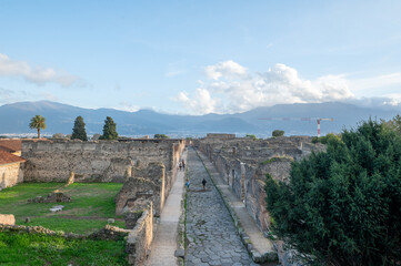 Cityscape of Ancient Pompeii (UNESCO World Heritage Site). Paving stones of Via del Foro in November 2023.