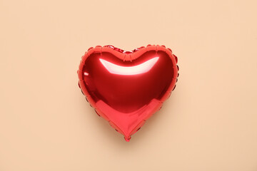 Heart shaped air balloon on beige background. Valentine's Day celebration