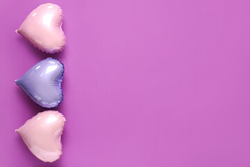 Heart shaped air balloons on purple background. Valentine's Day celebration