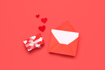 Gift box with envelope and hearts on red background. Valentine's Day celebration