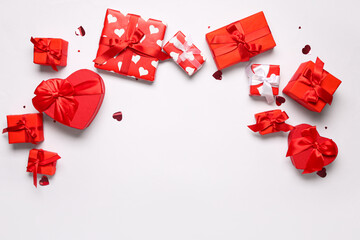 Many gift boxes and confetti on white background. Valentine's Day celebration